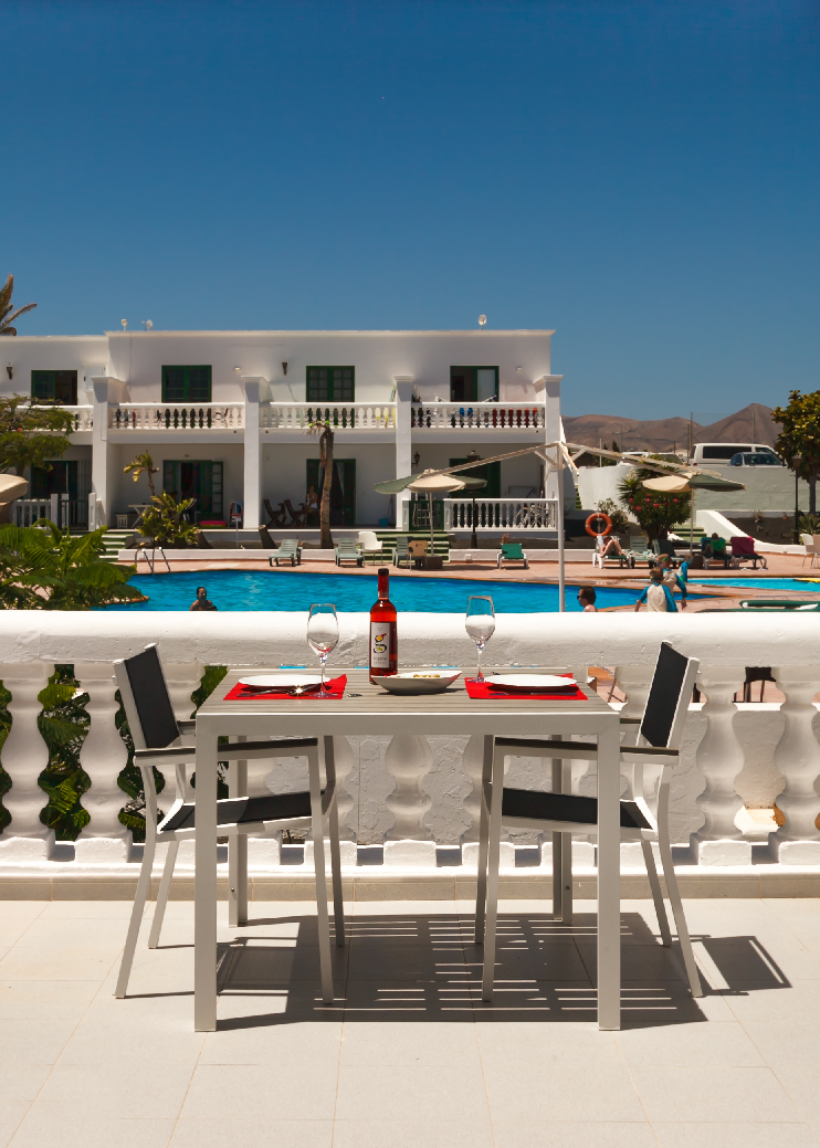 Private terrace dining table at Loma Verde with pool view in Puerto del Carmen
