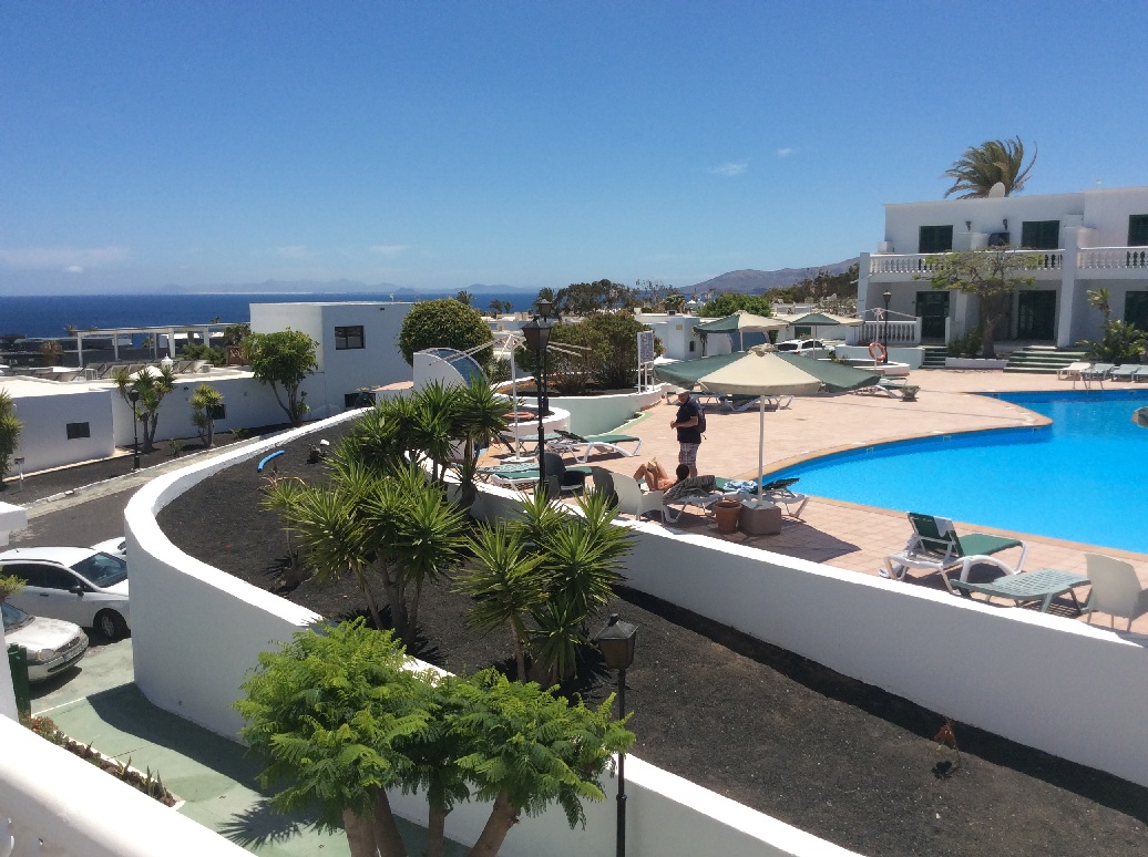 Sea and pool views from Loma Verde apartment terrace in Lanzarote